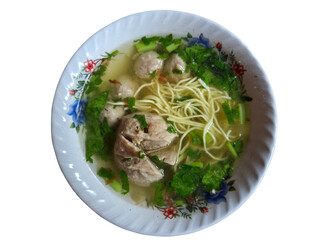 Overhead shot of clear soup with noodles, green vegetables, and meatballs in ceramic bowl isolated on transparent background. PNG transparency. Bakso