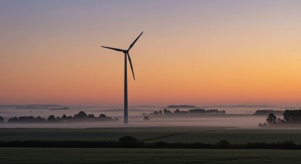 A tall turbine spins against a vibrant sunrise sky, hovering above a misty landscape. Fields and distant trees add depth