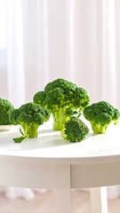 Fresh broccoli heads on a white table