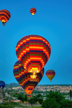Colorful hot air balloons flying over Cappadocia at sunrise in Turkey