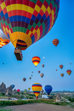 Colorful hot air balloons flying over Cappadocia at sunrise in Turkey
