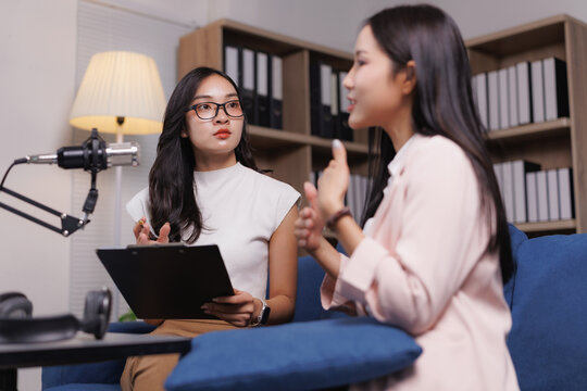 Podcasters discussing during recording session in modern studio