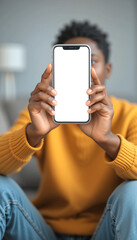 African American boy holding smartphone with blank screen, ideal for kid-friendly app mockups & youth tech advertising.