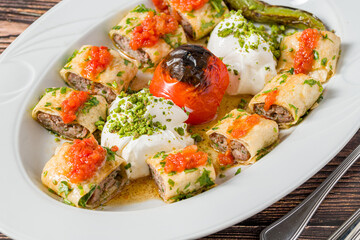 Beyti kebab rolled in lavash with yogurt, tomato sauce and grilled tomato