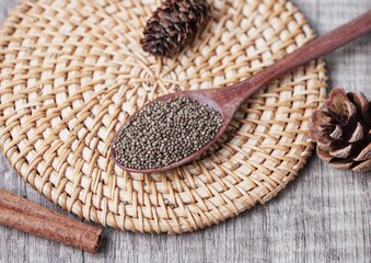 Close up of chia seeds in a wooden spoon. Chia seeds contain fiber and omega-3 fatty acids and protein.