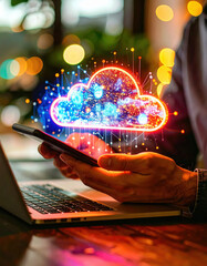 Photography of a person using the phone and labtop with cloud icon on the screen.