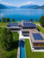 Aerial view of a luxury modern villa with rooftop solar panels and a swimming pool, set against a scenic lake and mountain landscape.