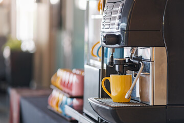 a espresso coffee making machine doing a cup of cappuccino during a day time meeting in the...