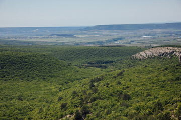 Obraz premium landscape on the mountains, green forest and blue sky with clouds