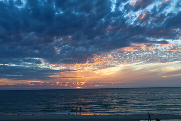 Dramatic ocean sunset with golden rays and glowing clouds, Australia