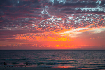 Dramatic ocean sunset with golden rays and glowing clouds, Australia