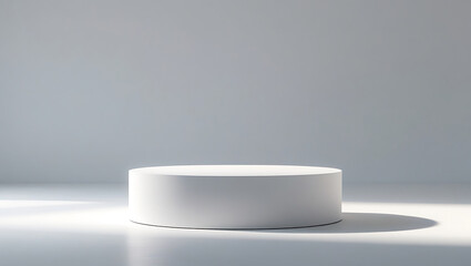 Minimalist white cylindrical podium with dramatic lighting and soft shadow.