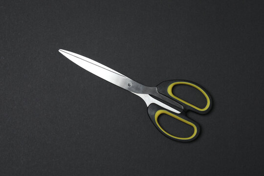 Scissors on black background, flat design. Place for text.
