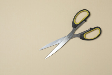 Scissors on beige background, flat design. Place for text.
