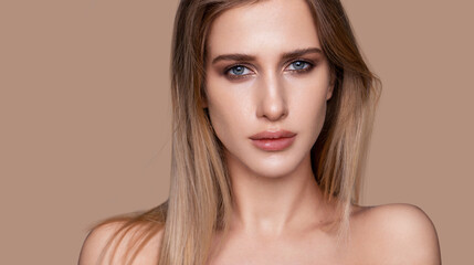 Natural beauty portrait with soft lighting and neutral background.
