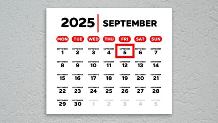The date September 5th marked with a red cursor on the wall calendar 2025