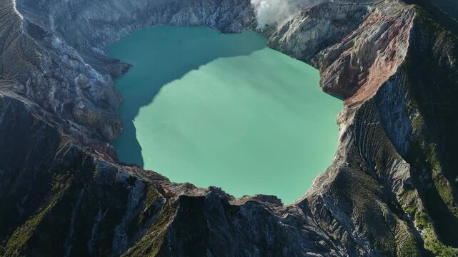 Aerial view of Kawah Ijen volcano with turquoise sulfur water lake at sunrise.Amazing nature landscape view at East Java, Indonesia. Natural landscape background
