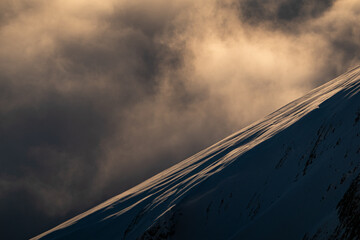 Golden Clouds over Mountain Ridge at Sunset