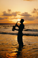 A highly skilled saxophonist is passionately playing enchanting melodies against a stunning beach sunset during dusk