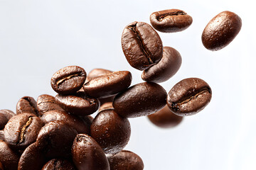 Fototapeta premium A bunch of coffee beans and falling coffee beans on a white background. Isolated.