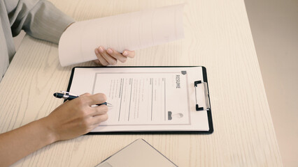 Businesswoman employer holding resume, recruiting, planning, evaluating and reviewing resume of job...