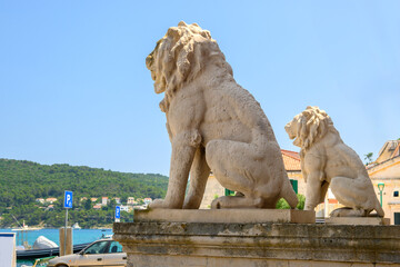 Stone lion in front of the town hall in Pucisca town on the island of Brac. Croatia