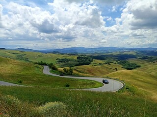 Tuscan landscape with winding road and hills
