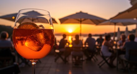 Spritz cocktail at sunset with people dining in the background