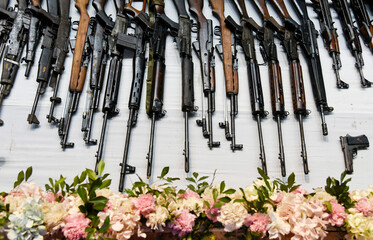 A row of vintage assault rifles on display after surrender by a revolutionary group