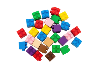 Colorful toy building blocks, red, blue, yellow, pink, purple, green, brown, scattered on an immaculate white background with copy space, top-down, concept of childhood learning and imagination