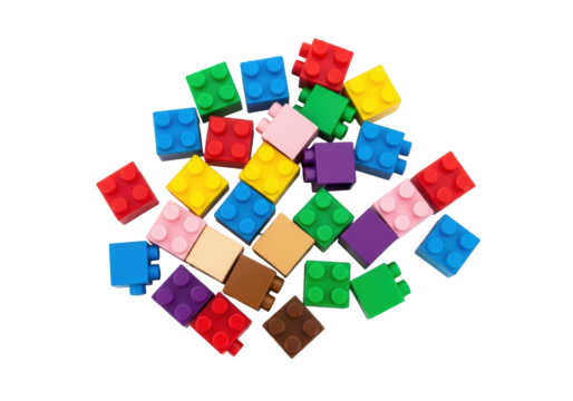 Colorful toy building blocks, red, blue, yellow, pink, purple, green, brown, scattered on an immaculate white background with copy space, top-down, concept of childhood learning and imagination