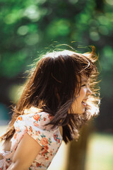 Joyful girl enjoying nature in a sunny environment.