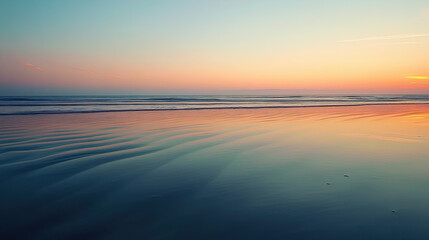 Fototapeta premium Tranquil ocean waves at sunset with soft ripples and colorful reflections on wet sand, peaceful beach landscape perfect for nature backgrounds, relaxation moods, and serene travel visuals 