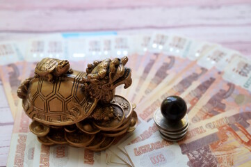 A dragon turtle statuette and a tiger's eye stone ball.