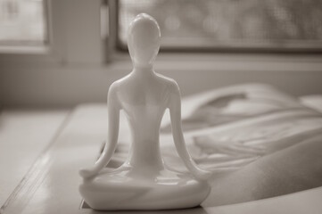 A figure of a woman in the lotus position. Health and harmony.