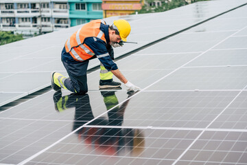 Workers install solar panels on a rooftop in an urban setting during daylight hours focused on...