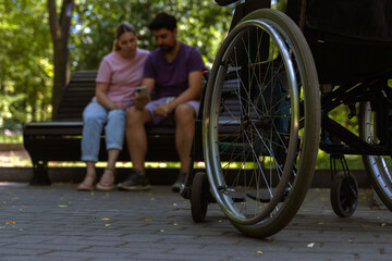Wheelchair Focused in Urban Park Setting with Couple