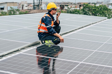 Technician inspects solar panels on rooftop during bright day in urban area while communicating...