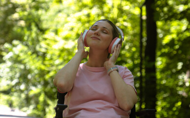 Young Woman Enjoying Music on Headphones Outdoors