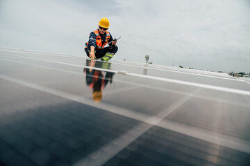 Technician inspects solar panels on rooftop in urban area during overcast day