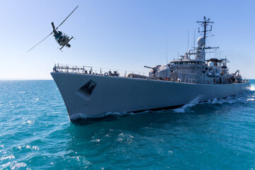 A helicopter flies over a warship during a naval exercise in the Black Sea  © ValStock
