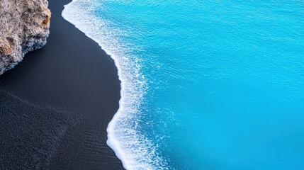 Black sand formed by volcanic eruptions, creating a striking and unique coastal environment.