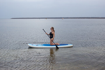 Woman on Stand Up Paddle Board, SUP, Active Life Concept. Woman paddleboarding