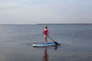 Woman on Stand Up Paddle Board. SUP. Attractive Woman on Stand Up Paddle Board, SUP
