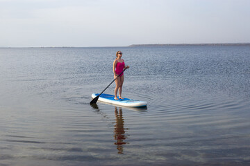 Woman on Stand Up Paddle Board. SUP. Attractive Woman on Stand Up Paddle Board, SUP