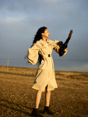 Stylish young Asian woman in a dramatic outdoor pose.