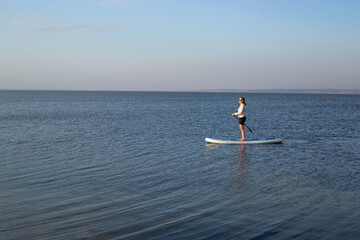 Woman on Stand Up Paddle Board, SUP, Active Life Concept. Woman paddleboarding