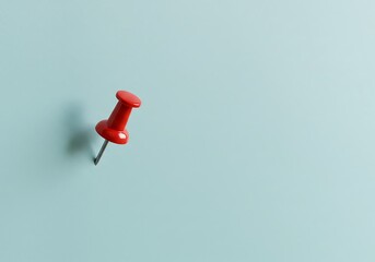Minimalist close-up of a single red pushpin stuck into a light blue wall, casting a soft shadow—symbolizing focus, reminder, or planning.