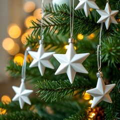 White star Christmas ornaments hanging on green tree branch with warm holiday lights