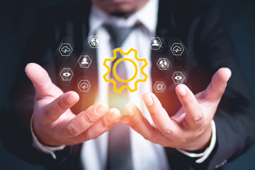 Hand of professional manager controlling virtual cogwheel mechanism. Business Process Management and Automation Concept.